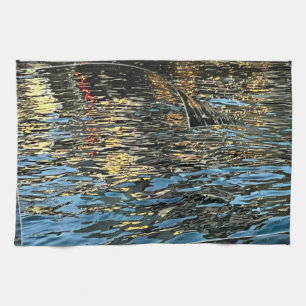 Evening lights on the sea tea towel