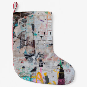 Exposed weathered brick wall with torn street post small christmas stocking