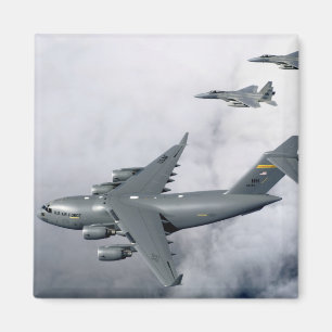 F-15B Eagles escort the first Hawaii-based C-17 Magnet