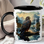 Falcon in Mountain Wilderness  Mug<br><div class="desc">Embrace the majesty of nature with the Falcon in Mountain Wilderness Mug. This striking mug features a detailed image of a falcon perched on a branch, set against a backdrop of rugged mountains and dense forests. Customised with your name, it adds a personal touch that makes it uniquely yours. Perfect...</div>