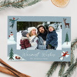 Falling Snow Whimsical Winter Scene Photo Holiday Card<br><div class="desc">A cute holiday card featuring your horizontal photo surrounded by illustrations of a person throwing a snowball,  a snowman,  pine trees,  a deer,  a sled with presents,  and a person making a snow angel. "Warmest Wishes" is displayed in a white hand-lettered script with your family name shown below.</div>