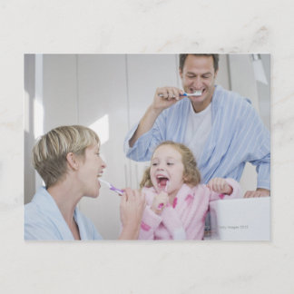 Family brushing teeth together postcard