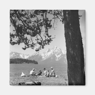 Family having picnic by lake mountains magnet