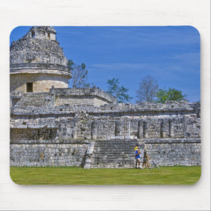 Family of tourists walk past ancient Mayan Mouse Pad