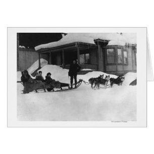 Family travelling by Dog Sled in Alaska