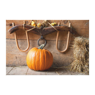 Farmers Museum. Pumpkin in barn with bale of hay Canvas Print