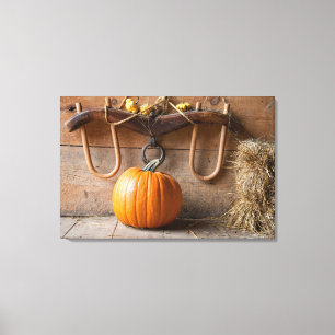 Farmers Museum. Pumpkin in barn with bale of hay Canvas Print