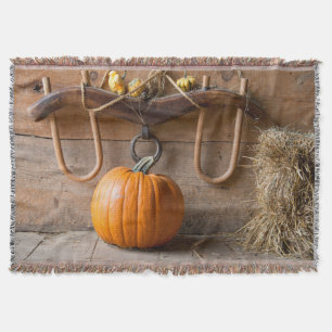 Farmers Museum. Pumpkin in barn with bale of hay Throw Blanket