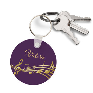 Faux gold music notes on elegant purple backdrop key ring