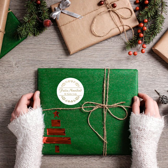 Feliz Navidad Christmas Golden Classic Round Sticker (Spanish Feliz Navidad sticker, golden text & wreath, custom family name & text. ConJesusenelCamino)