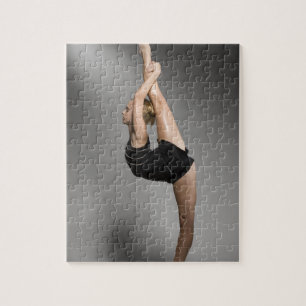 Female gymnast stretching, studio shot jigsaw puzzle