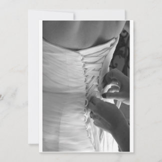 Female hand lacing up wedding dress back