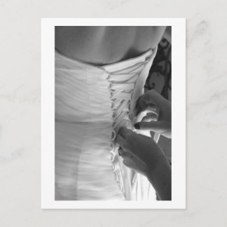 Female hand lacing up wedding dress back postcard