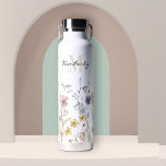Feminine Boho Botanical Wildflowers with Monogram Water Bottle<br><div class="desc">Contemporary with a fresh feminine look, this lovely water bottle is bordered along the bottom in watercolor wildflowers with beautiful soft pastel colours of yellow, pink, blue and ivory beige. A text template is included to personalise with a first name and monogram initial of the last name. This high quality...</div>