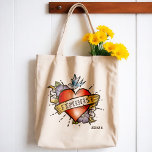 Feminist Tote Bag<br><div class="desc">Feminist Tote Bag - This funky tote bag features a realistic tattoo heart with a vintage style banner and the word Feminist. A great gift idea for young women finding their way. Seize the day and show who's in charge with this awesome feminist tote bag.</div>