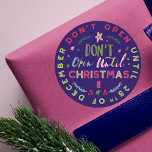 Festive, Fun & Colourful Do Not Open Til Christmas Classic Round Sticker<br><div class="desc">No peeking! safeguard your Christmas presents from your sneaky peekers with our fun, whimsical and colourful "Don't Open until Christmas" stickers. The Design features different fun and bold typographic typography to create a fun design. Bright colours of reds, pinks, greens, blues and faux gold accents against a dark navy blue...</div>