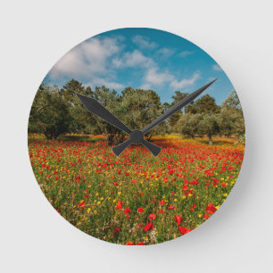 field with flowers and trees round clock