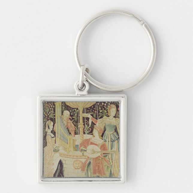 Figures around a fountain key ring (Front)