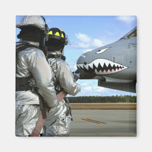 Firefighters deploy a fire hose during a drill magnet