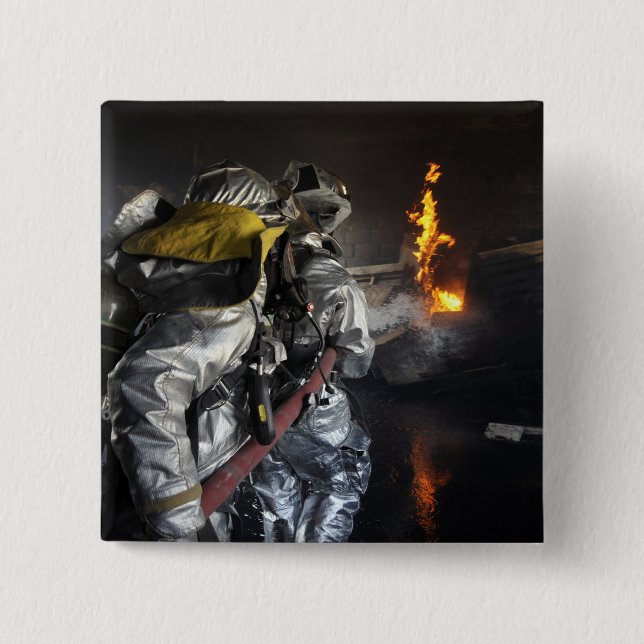 Firefighters extinguish a fire in a training ro 15 cm square badge (Front)