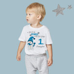 First Birthday Winter Onderland Snowman Boy  Baby T-Shirt<br><div class="desc">Winter Onederland 1st first birthday party,  holiday Christmas WinterT-shirt. Cute Little Snowman with blue beanie and scarf,  beautiful snowflakes and a light blue colour decorate the background. You can personalise this adorable invitation with your own text and photo.</div>