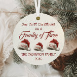 First Christmas As A Family Of Three Personalised Metal Tree Decoration<br><div class="desc">Celebrate the joy of your First Christmas As A Family Of Three with this beautifully crafted Personalised Metal Ornament. Featuring charming Santa hats and a vintage script typeface, this ornament is the perfect way to commemorate the start of your family's holiday traditions. Whether you're welcoming a newborn or cherishing the...</div>