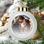 First Christmas Engaged Custom Photo Grey Script<br><div class="desc">Commemorate your engagement with this beautiful modern keepsake ornament. The charcoal grey text reads "Our first Christmas engaged, " with the word "engaged" in elegant script with swashes before and after. Replace the sample image with your favourite photo, and add your names and the year. A white gradient filter helps...</div>