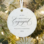 First Christmas Engaged Ornament<br><div class="desc">Celebrate your first Christmas as an engaged couple with this timeless, minimalist ornament. Featuring a classic black and white design with elegant script fonts and a soft white background, adorned with delicate white pearls, this ornament exudes sophistication and charm. The perfect keepsake to commemorate this special moment in your love...</div>