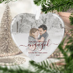 First Christmas Engaged Photo Red Script Heart Ornament<br><div class="desc">Commemorate your engagement with this beautiful heart-shaped keepsake ornament. The dark red text reads "Our first Christmas engaged, " with the word "engaged" in elegant handwriting script with flourishes before and after. Replace the sample image with your favourite photo, and add your names and the year. A white gradient filter...</div>