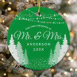 First Christmas Mr Mrs Green Winter String Lights Ceramic Tree Decoration<br><div class="desc">Celebrate the newlyweds' first Christmas with this charming ceramic ornament. The design features a green winter string lights backdrop with the words "Mr. & Mrs." in a classic script. This personalised keepsake makes a thoughtful wedding or housewarming gift. The high-quality ornament comes ready to hang and is sure to be...</div>