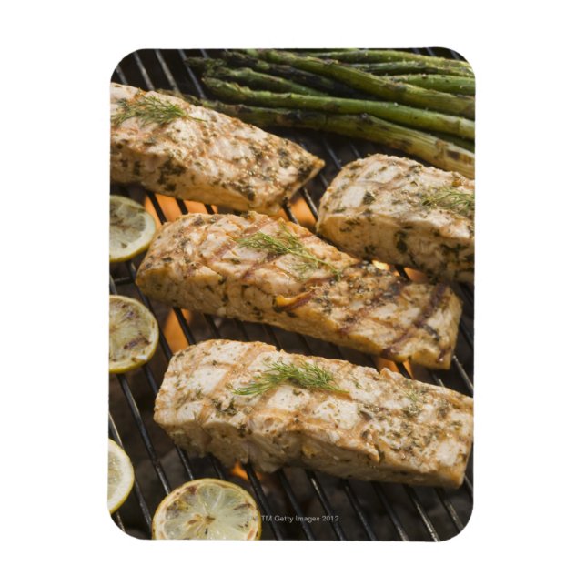 Fish and asparagus cooking on grill magnet (Vertical)