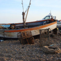 fishing boat on pebble beach seaside