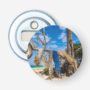 Fishing nets drying on the beach bottle opener