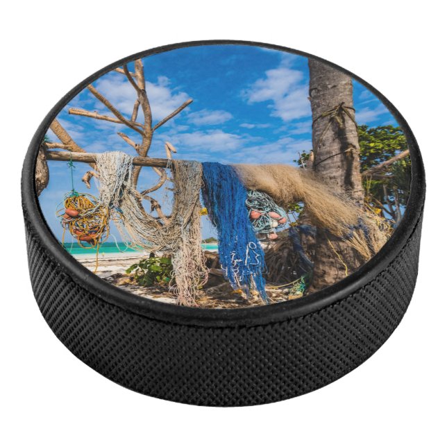 Fishing nets drying on the beach hockey puck (3/4)