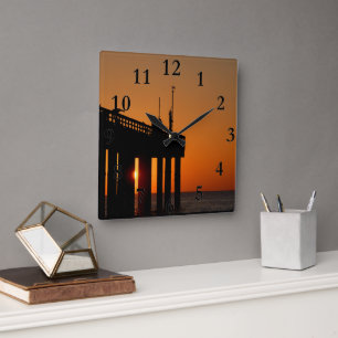 fishing pier at sunrise square wall clock