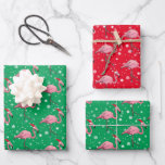 Flamingoes in  Santa Hats Christmas Wrapping Paper Sheet<br><div class="desc">A pattern of pink flamingoes wearing Santa hats and wading in water. Snowflakes complete the holiday theme.</div>
