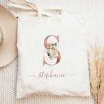 Floral Ivory Rose Gold Monogram Letter S Tote Bag<br><div class="desc">This elegant tote bag features a large letter "S" monogram in faux rose gold foil, decorated with a vintage ivory floral bouquet trimmed with green and rose gold foliage. Personalise it with her name in rose gold handwriting script, with flourishes at the beginning and end. Makes a perfect bridesmaid gift!...</div>