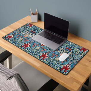 Floral pattern on green leaves blue background desk mat