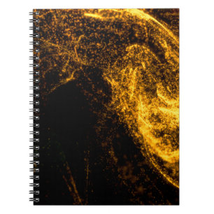 Fluid gold colour particles flowing beautiful with notebook