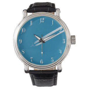 Flying aeroplane on a blue sky background watch