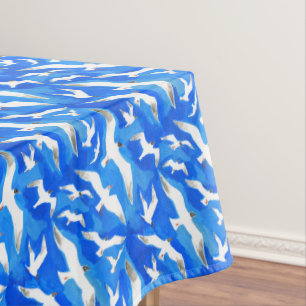 Flying seagulls on sky blue tablecloth