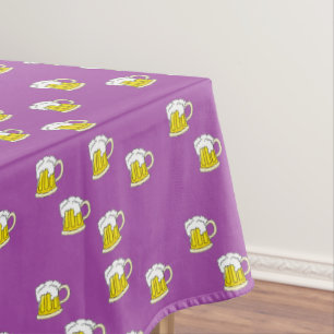 Foaming beer cup on purple tablecloth