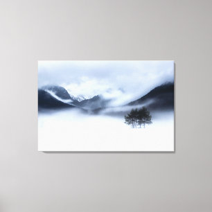 Fog, mountains and lonely tree in winter canvas print