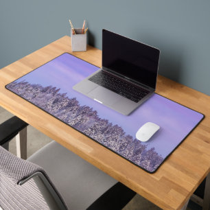 Foggy snow covered spruce forest at sunset desk mat