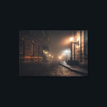Foggy Victorian Cobblestone Alley Glow Canvas Print<br><div class="desc">Thick fog envelops a narrow Victorian cobblestone alley lit by warm amber street lamps mounted on elegant wrought-iron brackets. Tall Georgian brick buildings with tall windows rise on both sides, their details softened by the mist that turns every light into a glowing halo. The curving lane fades into impenetrable darkness,...</div>