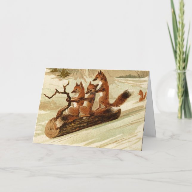 Folded CHRISTMAS Card FOXES ON LOG SLEDDING (Front)