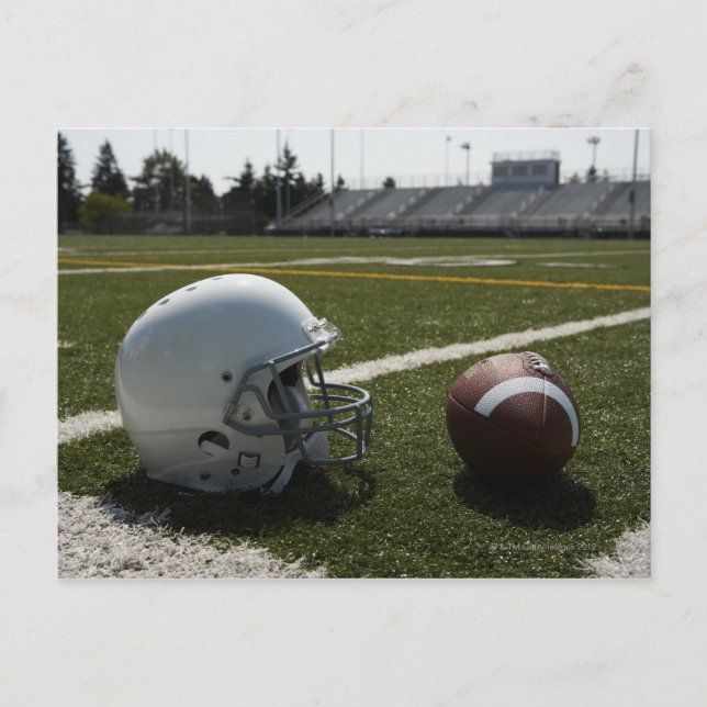 Football and football helmet on football field postcard (Front)