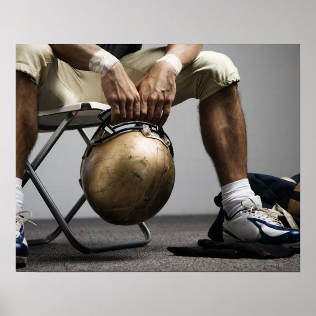 Football player sitting in locker room poster (Front)