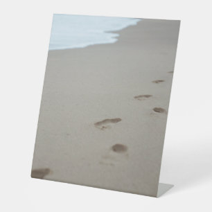 Footprints on a white beach in Mozambique Pedestal Sign