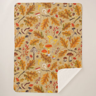 Forest mushrooms and autumn flora on ochre sherpa blanket